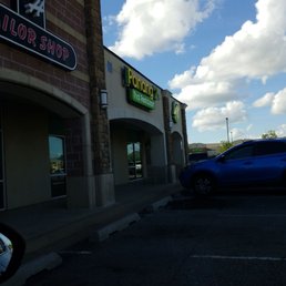 a blue car parked in front a blue car parked in front