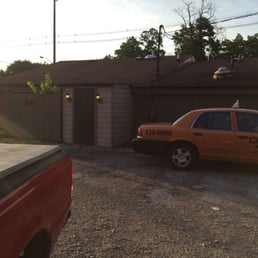 a taxi cab parked in front of a garage a taxi cab parked in front of a garage