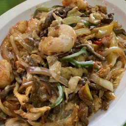This paella had a light cheese sauce over the grilled meat, shrimp and vegetables.