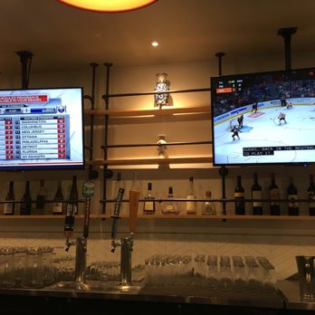 Woking Dragon - a hockey game being played on a big screen - Chinese Near Me - Coquitlam, British Columbia