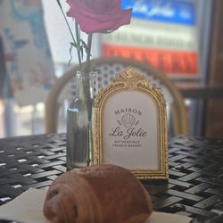 A chocolate criosant on one of their beautiful tables with fresh flowers every day!