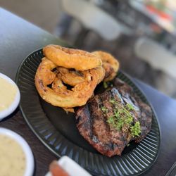 Sage Restaurant & Lounge - Ribeye served w/ house made Onion Rings