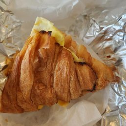 Half of egg and cheese on crossiant Half of egg and cheese on crossiant