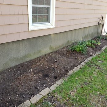 High Performance Tree & Lawn - a small garden in front of a house - Lawn Services Near Me