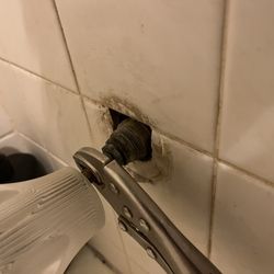 Access Dermatology - Tub/shower nozzle - taken off and wrench used to stop water leak.