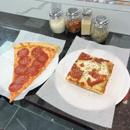 two slices of pepperoni pizza on paper plates