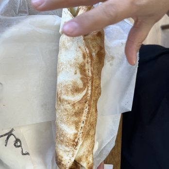 Phoenicia Mediterranean Deli - Chicken Shawarma Sandwich, wife couldn't get her hand out of the way fast enough.  Another great sandwich. - Mediterranean Near Me - Ballwin, Missouri