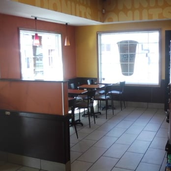Dunkin' - the inside of a restaurant with tables and chairs - Donuts Near Me - Torrington, Connecticut Dunkin' - the inside of a restaurant with tables and chairs - Donuts Near Me - Torrington, Connecticut