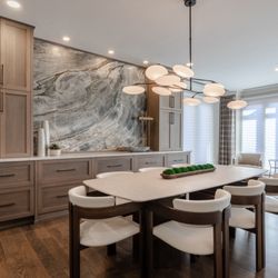 Modern Dining Room with slab accent wall, and custom draperies
