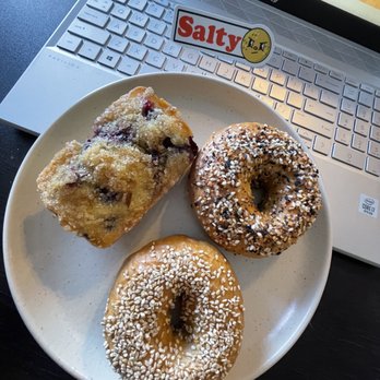 Salty Bagel - three donuts on a plate with a laptop in the background - Bagels Near Me Salty Bagel - three donuts on a plate with a laptop in the background - Bagels Near Me