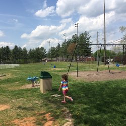 Lots of trash cans and picnic benches