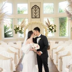 Sunset Gardens - The wedding chapel decorated with floral centerpieces down the aisle.