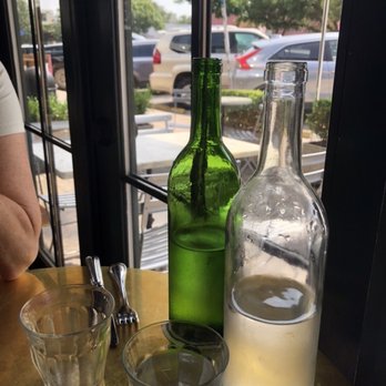 June's - Bistro table view- overlooking patio...our never ending bottles of water! - Breakfast & Brunch Near Me - Austin, Texas