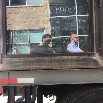 Fiore Wood Fired Pizza - Hard to see the menu in the light! - Food Trucks Near Me
