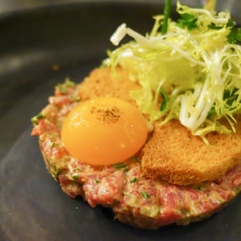 Spoon and Stable - Bison Tartare-
cornichons, herb salad, chicken egg yolk - New American Near Me - Minneapolis, Minnesota Spoon and Stable - Bison Tartare-
cornichons, herb salad, chicken egg yolk - New American Near Me - Minneapolis, Minnesota