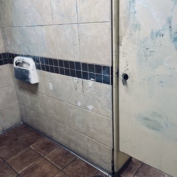 Fred Meyer - a dirty bathroom with a toilet paper dispenser - Department Stores Near Me - Sumner, Washington