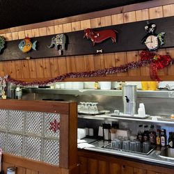 View of the kitchen and clocks on the wall above the pass-through.