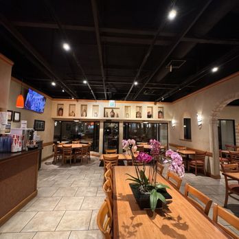 Waterfront Pizza - a restaurant with a long wooden table and chairs - Pizza Near Me - Foster City, California