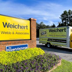 Weichert, Realtors® - Webb & Associates - Storefront sign and client moving truck