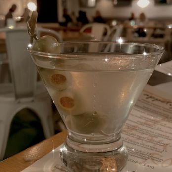 Southern Roots - Dirty martini with dining room view in the background - Southern Near Me - Jamestown, North Carolina