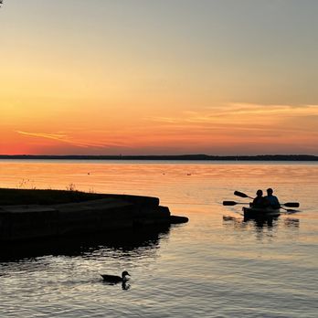 Ahan - two people in a canoe on a lake at sunset - Laotian Near Me - Madison, Wisconsin Ahan - two people in a canoe on a lake at sunset - Laotian Near Me - Madison, Wisconsin