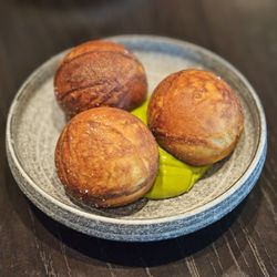 Published on Main - Ableskiver $19: three savoury danish donuts stuffed with stewed herbs and served a top a fresh herb emulsion