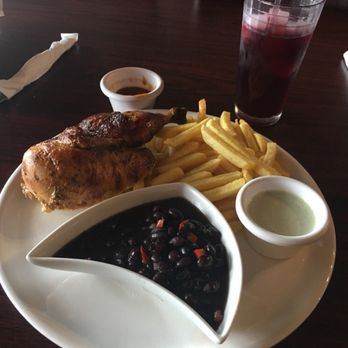 Peru Gourmet - Roasted chicken with black beans and French fries.. Glass of chicha in the corner! - Peruvian Near Me - Houston, Texas