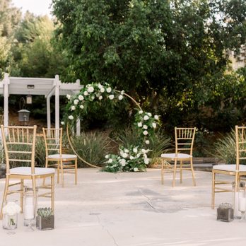 NPD Events - Our socially-distanced backyard ceremony site. Infinity arch, gold chiavari chairs, and accents by NPD. - Wedding Planning Near Me - Tustin, California NPD Events - Our socially-distanced backyard ceremony site. Infinity arch, gold chiavari chairs, and accents by NPD. - Wedding Planning Near Me - Tustin, California