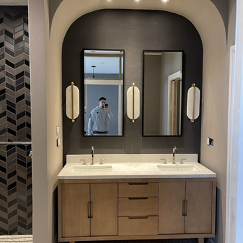 Ruben’s Crew Construction - a bathroom with double sinks and mirrors - General Contractors Near Me