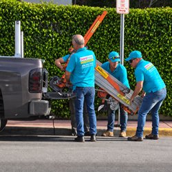 Bora HVAC - BORA HVAC team coordinating equipment handling and lift logistics for a package unit replacement in Miami Beach.