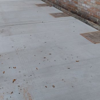 ZG Concrete Solutions - Driveway next to home, showing access ports for home foundation piers. - Masonry/Concrete Near Me - Houston, Texas ZG Concrete Solutions - Driveway next to home, showing access ports for home foundation piers. - Masonry/Concrete Near Me - Houston, Texas