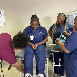 Milwaukee Career College - Medical assistant students learning how to conduct a patient physical.
