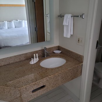Fairfield by Marriott Inn & Suites Miami Airport South - Sink area (closet with blow dryer, iron, ironing board, and extra blankets to the left) - Hotels Near Me - Miami, Florida
