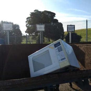 SMaRT Station - 40 pound microwave hoisted over the 5 foot high lip of the dumpster - Recycling Center Near Me - Sunnyvale, California SMaRT Station - 40 pound microwave hoisted over the 5 foot high lip of the dumpster - Recycling Center Near Me - Sunnyvale, California