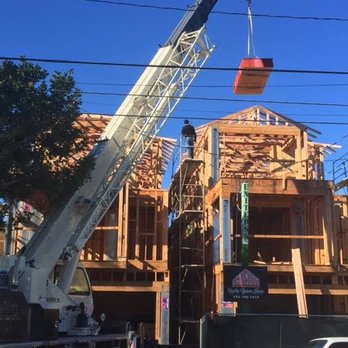 Axcell Developement - a crane working on a building - General Contractors Near Me