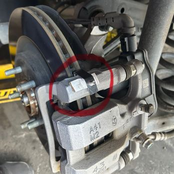 MGP Caliper Covers - This is the clip on the rear brake caliper that doesn't fit correctly and the installer added a piece of paper to help secure clip - Auto Parts & Supplies Near Me - Chula Vista, California MGP Caliper Covers - This is the clip on the rear brake caliper that doesn't fit correctly and the installer added a piece of paper to help secure clip - Auto Parts & Supplies Near Me - Chula Vista, California
