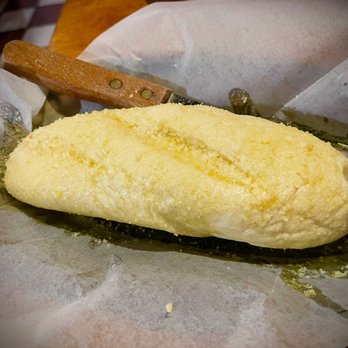 GINO's Restaurant & Bar - Garlic Bread - undercooked and bathed in garlic butter. - Italian Near Me - Tampa, Florida GINO's Restaurant & Bar - Garlic Bread - undercooked and bathed in garlic butter. - Italian Near Me - Tampa, Florida
