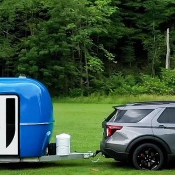 Cortes Campers - Camper being towed with SUV - RV Dealers Near Me - Euclid, Ohio