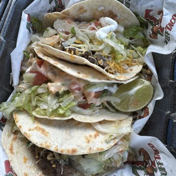 Tuff Taco - Steak tacos - Three tacos with lettuce, cheese, and meat, served on a paper-lined tray with a lime wedge, from a Mexican-style food truck. - Food Trucks Near Me - Dearborn, Michigan