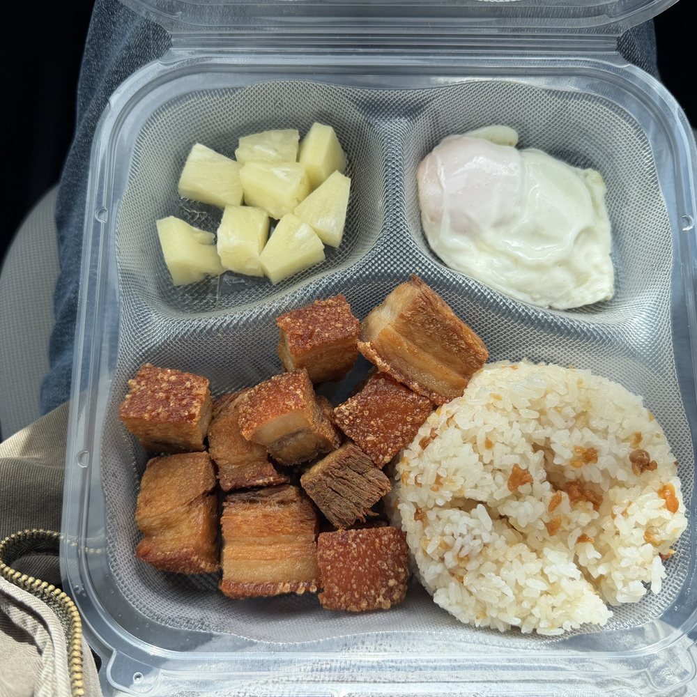 Lechon Kawalisilog (Crispy fried pork belly) with garlic rice, easy egg, and pineapple. Lechon Kawalisilog (Crispy fried pork belly) with garlic rice, easy egg, and pineapple.