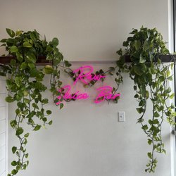 Ruby neon pink sign entangled with pothos that I love so much.