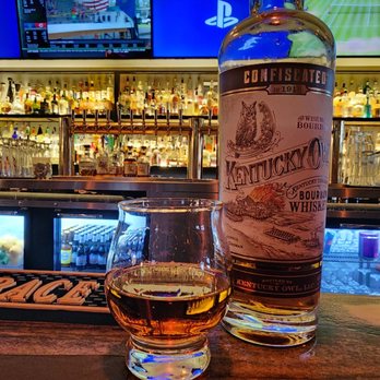 Phoenix Bourbon Room - a glass of whiskey and a bottle of whiskey - Cocktail Bars Near Me - Phoenix, Arizona