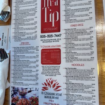 Thai Tip - Menu - The menu page from Thai Tip Restaurant features sections for appetizers, fried rice, and noodles. Appetizers include egg rolls, shrimp tempura, and chicken satay, with prices ranging from $4.95 to $6.50. Fried rice options include fried rice and Thai tam fried rice, priced at $15.95. Noodle dishes include Pad Thai, fried noodle, and Thai chow mein, with prices from $15.99 to $16.99. The menu emphasizes choice of protein, spice level, and includes a note about the restaurant's high-quality ingredients and ordering process. Contact information and address are provided at the bottom. - Thai Near Me - Albuquerque, New Mexico