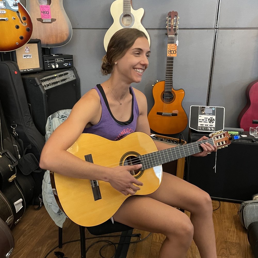 Behind the counter testing guitars