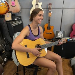 Behind the counter testing guitars Behind the counter testing guitars