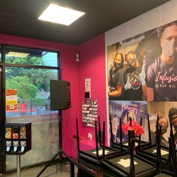 Infusion Crab ATL - a pink room with chairs and a speaker - Seafood Near Me - Marietta, Georgia