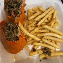 Philly cheesesteak wrap on tomato basil with fried