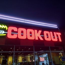 a neon sign in front of a restaurant