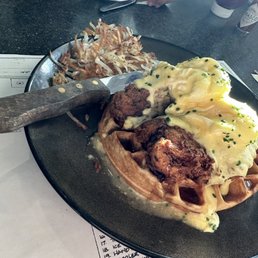 Chicken and waffles with poached eggs and hash browns