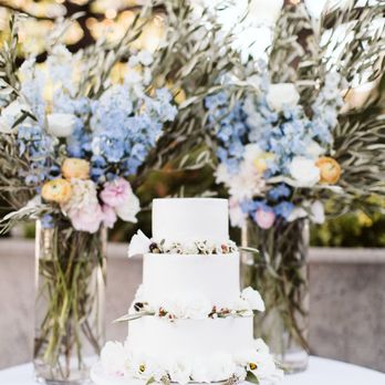 Perry Florals - Lovely alter pieces that got reused for the cake table and delicate florals for the cake - Floral Designers Near Me